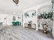 Modern dining area with green chairs, a glass table, and decorative accents at 2325 Pleasant Hill Ln, Holiday, FL 34691