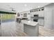 Spacious kitchen featuring modern cabinetry, granite island, and stainless steel appliances at 2325 Pleasant Hill Ln, Holiday, FL 34691