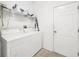 Bright laundry room with washer, dryer, and shelving at 2325 Pleasant Hill Ln, Holiday, FL 34691