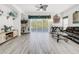 Bright living room with hardwood floors, ceiling fan, and access to a sliding door at 2325 Pleasant Hill Ln, Holiday, FL 34691