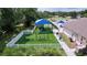 Community playground with swings, slide, and shaded seating at 2325 Pleasant Hill Ln, Holiday, FL 34691