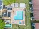 Aerial view of community pool, hot tub, and shuffleboard at 2400 Winding Creek Blvd # 25-101, Clearwater, FL 33761