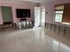 Living room with polished floors, pink walls, and a front door at 999 38Th Ne Ave, St Petersburg, FL 33704