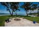 Backyard firepit area featuring a paved patio, water view, and landscaped yard at 4751 Baywood Point S Dr, Gulfport, FL 33711