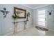 Elegant entryway featuring a decorative mirror, console table with flowers, and stylish tile flooring at 4751 Baywood Point S Dr, Gulfport, FL 33711