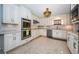 Well-appointed kitchen with white cabinetry, stainless steel appliances, and a decorative backsplash at 4751 Baywood Point S Dr, Gulfport, FL 33711