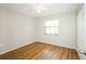 Simple bedroom with wood-look floors and a ceiling fan at 10608 Bucks Run, New Port Richey, FL 34654