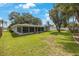 Spacious backyard with screened patio and lush lawn at 1995 Arvis E Cir, Clearwater, FL 33764