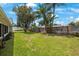 Large backyard with lush grass and wooden fence at 1995 Arvis E Cir, Clearwater, FL 33764