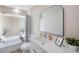 Modern bathroom with white vanity, large mirror, and bathtub at 1995 Arvis E Cir, Clearwater, FL 33764