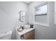 Modern bathroom with updated vanity, vessel sink, and window at 1995 Arvis E Cir, Clearwater, FL 33764