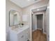 Clean bathroom with white vanity and access to hallway at 1995 Arvis E Cir, Clearwater, FL 33764