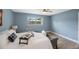 Relaxing bedroom with light blue walls, hardwood floors, and a ceiling fan at 1995 Arvis E Cir, Clearwater, FL 33764