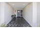 Inviting entryway with dark tile floors and bench at 1995 Arvis E Cir, Clearwater, FL 33764