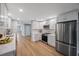 Modern kitchen with white cabinets, stainless steel appliances, and quartz countertops at 1995 Arvis E Cir, Clearwater, FL 33764