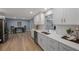 Modern kitchen with white shaker cabinets, quartz countertops, and stainless steel appliances at 1995 Arvis E Cir, Clearwater, FL 33764