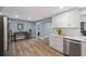 Modern kitchen with white shaker cabinets, quartz countertops, and stainless steel appliances at 1995 Arvis E Cir, Clearwater, FL 33764