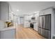 Modern kitchen with white shaker cabinets, quartz countertops, and stainless steel appliances at 1995 Arvis E Cir, Clearwater, FL 33764