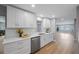 Modern kitchen with white shaker cabinets, quartz countertops, and stainless steel appliances at 1995 Arvis E Cir, Clearwater, FL 33764