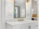 Elegant bathroom featuring a white vanity, gold accents, and a large mirror, showcasing chic design at 4132 4Th S St, St Petersburg, FL 33705