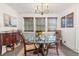 Bright dining room features updated lighting and a glass table for modern living at 4132 4Th S St, St Petersburg, FL 33705