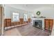 Living room featuring a fireplace, hardwood floors, and walls ready for renovation at 4132 4Th S St, St Petersburg, FL 33705