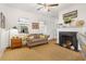 Cozy living room with fireplace, mantle, neutral toned couch, and natural light at 4132 4Th S St, St Petersburg, FL 33705