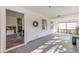 Bright living room with gray herringbone floors, white shiplap walls, and large windows offering natural light at 4132 4Th S St, St Petersburg, FL 33705