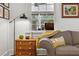 Cozy living room featuring a comfortable gray sofa, stylish accents, and natural light from the window at 4132 4Th S St, St Petersburg, FL 33705