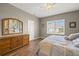 Bedroom with a queen-size bed, wood floors, and a large window at 6926 Surrey Oak Dr, Apollo Beach, FL 33572