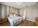 Large bedroom with a king-size bed, wood floors, and an ensuite bathroom at 6926 Surrey Oak Dr, Apollo Beach, FL 33572