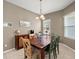 Dining room with a rustic wood table and six chairs at 6926 Surrey Oak Dr, Apollo Beach, FL 33572