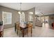 Bright dining room with a wooden table and chairs, view to living room at 6926 Surrey Oak Dr, Apollo Beach, FL 33572