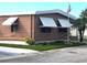 Side view of brown mobile home with American flag at 283 Pelican N Dr, Oldsmar, FL 34677