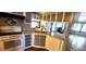 Eat-in kitchen with gray cabinets, white appliances, and wood flooring at 283 Pelican N Dr, Oldsmar, FL 34677