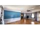 Living area with laminate wood floor and blue accent wall at 283 Pelican N Dr, Oldsmar, FL 34677