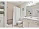 Clean bathroom with shower, white vanity, and built-in shelving at 19417 Gulf Blvd # B208, Indian Rocks Beach, FL 33785