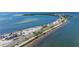 Aerial view of a beach and road along the water, showcasing the coastline and beach access at 2085 Hunters Glen Dr # 213, Dunedin, FL 34698