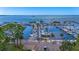 Aerial view showcasing a marina filled with boats, lush greenery, and open water creating a beautiful landscape at 2085 Hunters Glen Dr # 213, Dunedin, FL 34698