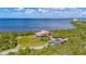 Stunning waterfront property featuring a unique stilt home, lush landscaping, and serene water views at 2085 Hunters Glen Dr # 213, Dunedin, FL 34698