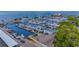 Beautiful aerial view of a marina filled with boats, with a waterfront restaurant and lovely views at 2085 Hunters Glen Dr # 213, Dunedin, FL 34698