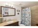 Bathroom featuring a vanity with a dark wood cabinet and a shower with a seashell patterned curtain at 2085 Hunters Glen Dr # 213, Dunedin, FL 34698