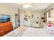 Cozy bedroom featuring a four-poster bed, ceiling fan, and television atop a wooden dresser at 2085 Hunters Glen Dr # 213, Dunedin, FL 34698