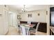 Bright dining area with glass table, modern chairs, and built-in storage cabinets at 2085 Hunters Glen Dr # 213, Dunedin, FL 34698