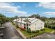 Apartment building exterior with palm trees and an arrow pointing to the unit entrance at 2085 Hunters Glen Dr # 213, Dunedin, FL 34698