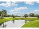 Community with a large, well-maintained pond with a fountain and landscaped surroundings at 2085 Hunters Glen Dr # 213, Dunedin, FL 34698