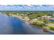 Waterfront view featuring a mix of residential and natural elements, including a street lined with mature trees at 2085 Hunters Glen Dr # 213, Dunedin, FL 34698