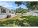 Spacious backyard featuring a lush lawn, white fence, and a patio area at 707 2Nd Se St, Largo, FL 33771