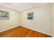 Clean, bright bedroom featuring hardwood floors and ample natural light from two windows at 707 2Nd Se St, Largo, FL 33771