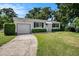 Well-maintained home featuring a green lawn and attached single-car garage at 707 2Nd Se St, Largo, FL 33771